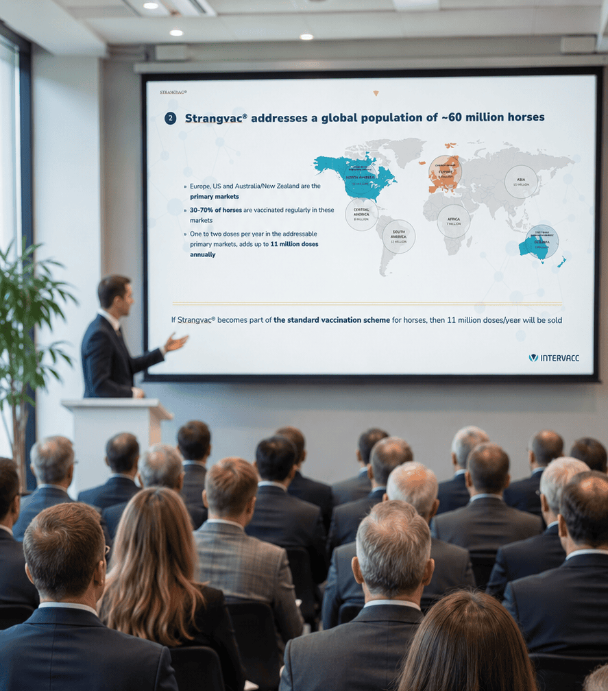 Articles_of_Association_short Audience at a meeting, a man presenting Intervacc via projector